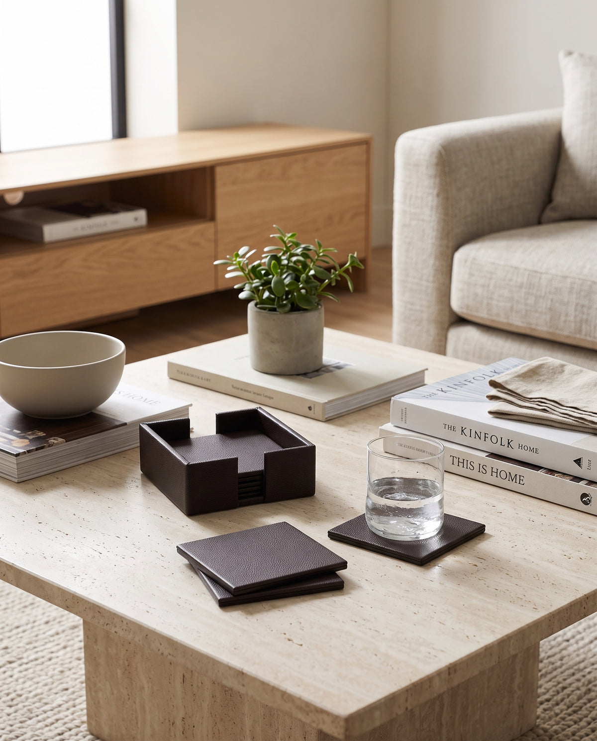 Cherry faux leather coaster set on a living room coffee table