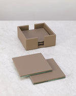 Pea green faux leather coaster holder with two coasters laid in front
