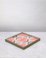 Green floral square tray lying flat on white, angled view