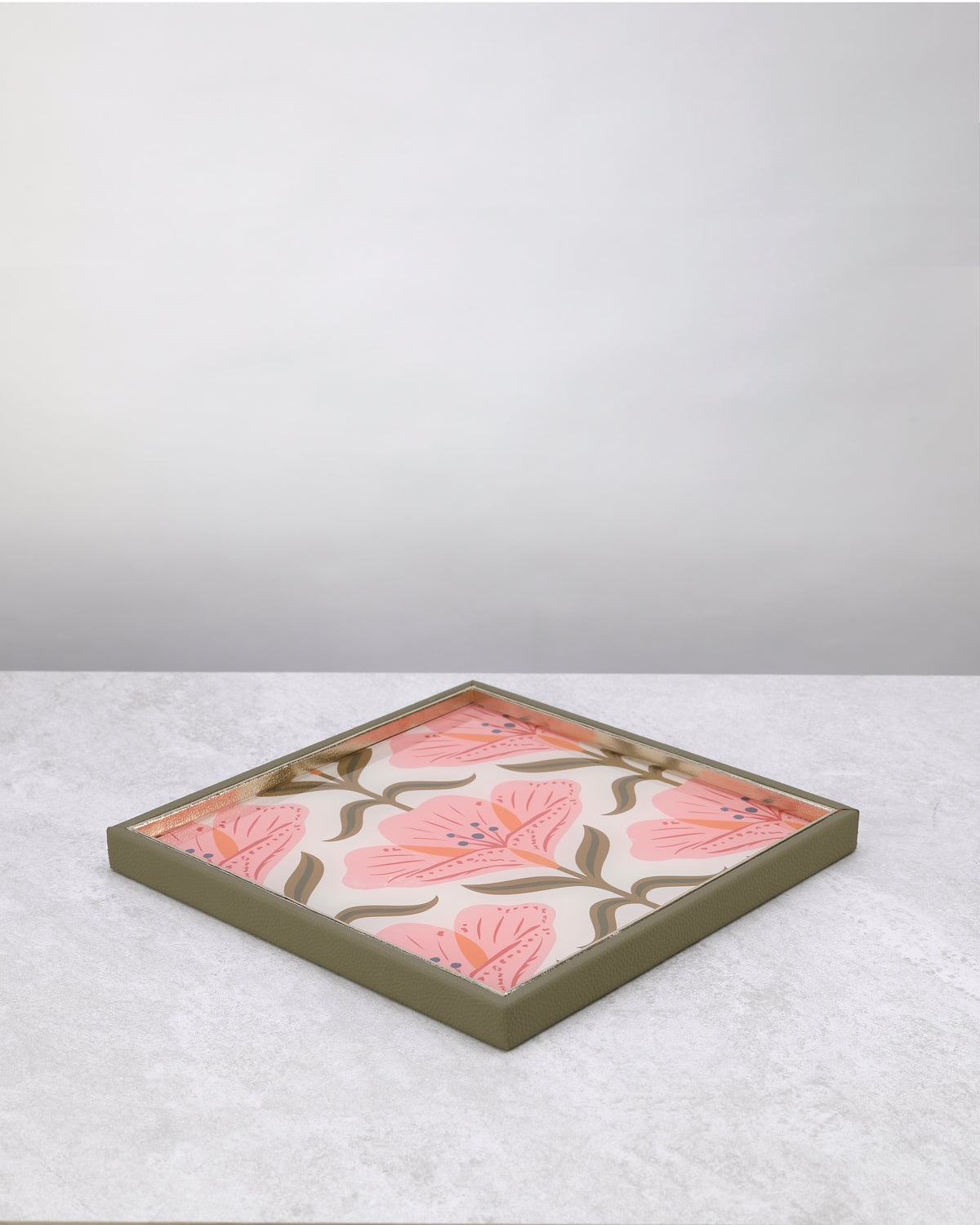 Green floral square tray lying flat on white, angled view
