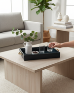 Hand setting a glass on the small navy croco tray on a side table