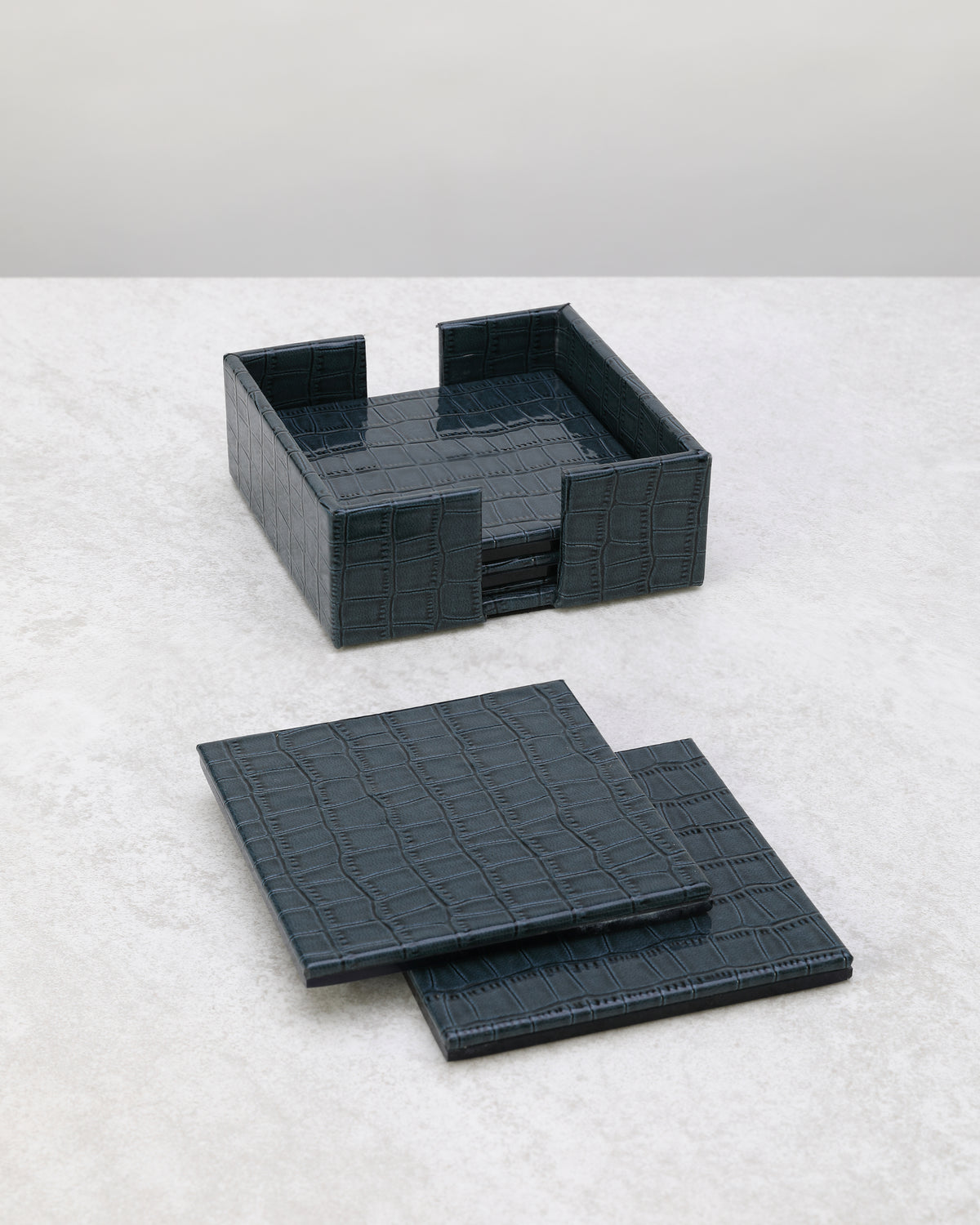 Navy blue faux leather coaster set with its square holder