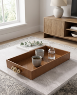 Small beige croco tray with glasses on a marble coffee table