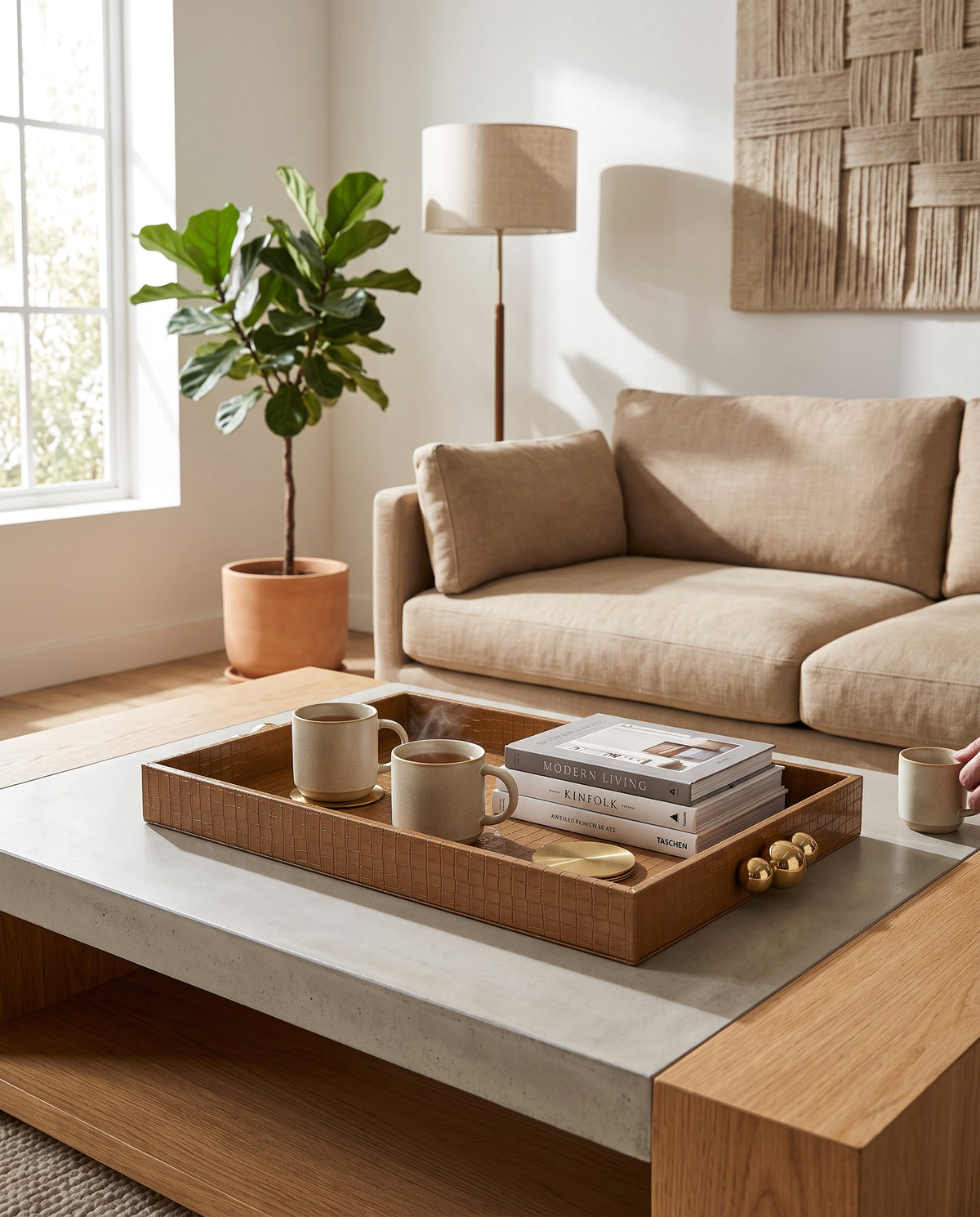 Large beige croco tray holding cups and books on a coffee table in a living room