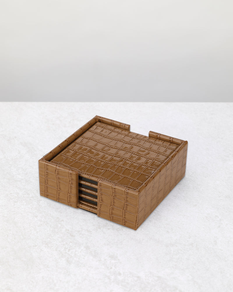 Beige faux leather coaster set stacked in its matching holder