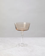Single coffee-brown coupe cocktail glass, front view