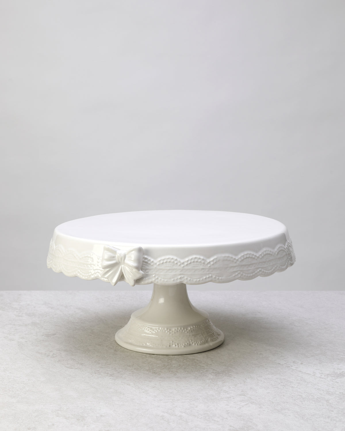 White glazed ceramic cake stand, side view