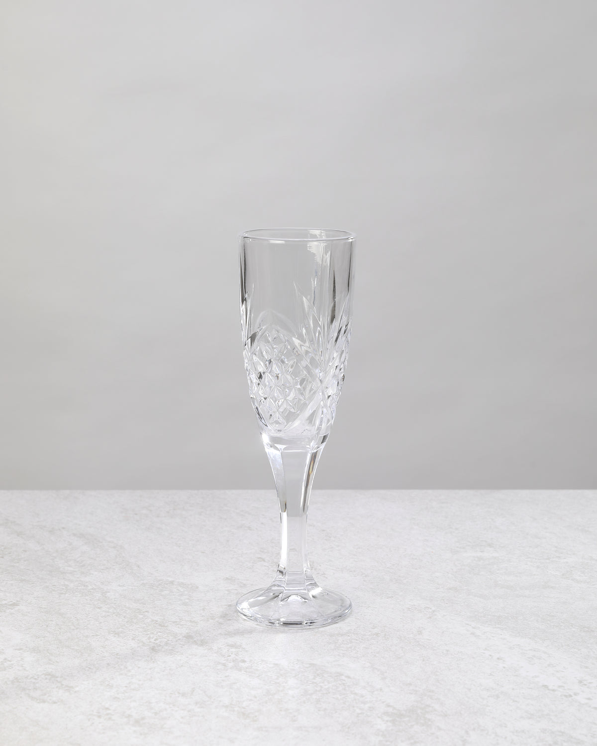 Single clear machine cut champagne flute, front view
