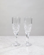 Pair of clear machine cut champagne flutes on a white background