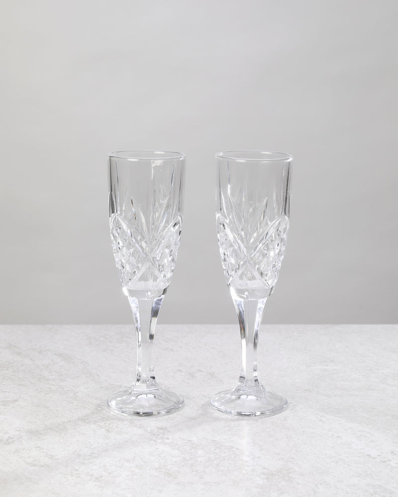 Pair of clear machine cut champagne flutes on a white background