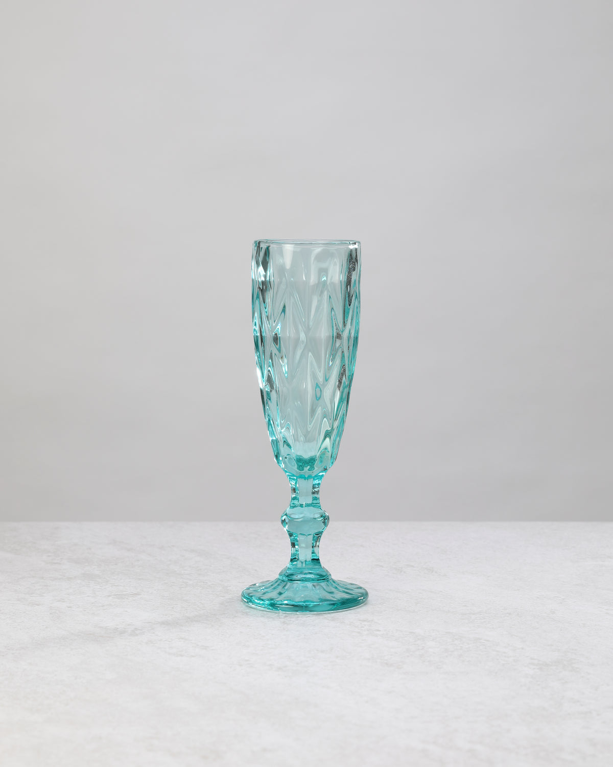Single aqua diamond cut champagne flute, front view