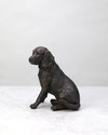 Black antique spaniel dog figure sitting, side view