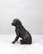 Black antique spaniel dog figure sitting, side view