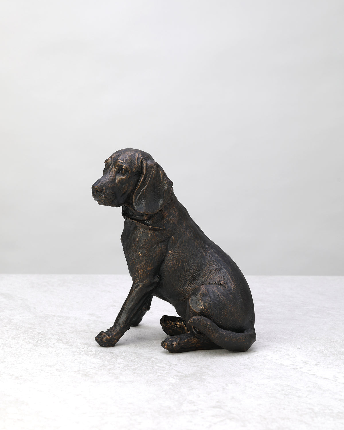 Black antique spaniel dog figure sitting, side view