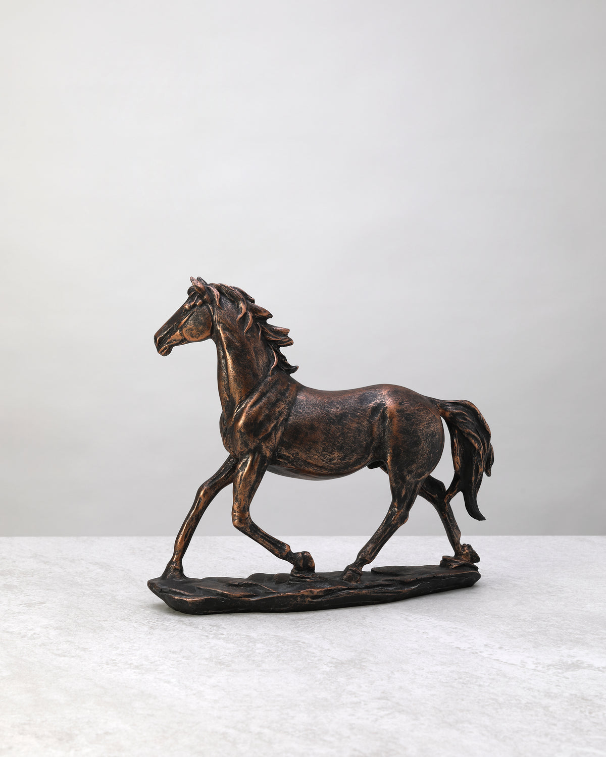 Bronze-finish resin horse figure in mid-stride