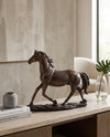 Resin horse figure on a console in a living room
