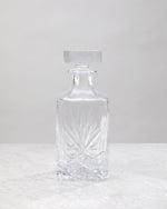 Clear machine cut decanter from the side, showing the cut pattern and stopper