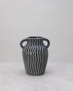 Grey ceramic decorative pot with ribbed sides and two small handles
