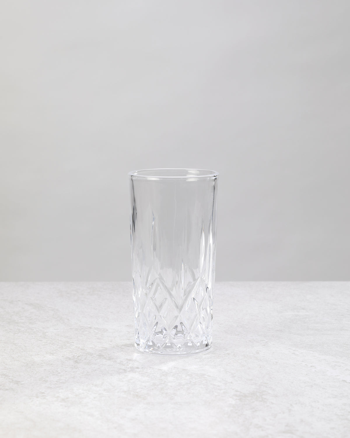 Single clear machine cut high ball glass, front view