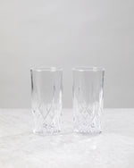 Pair of clear machine cut high ball glasses on a white background