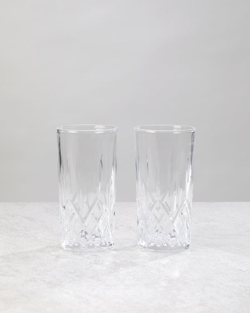 Pair of clear machine cut high ball glasses on a white background