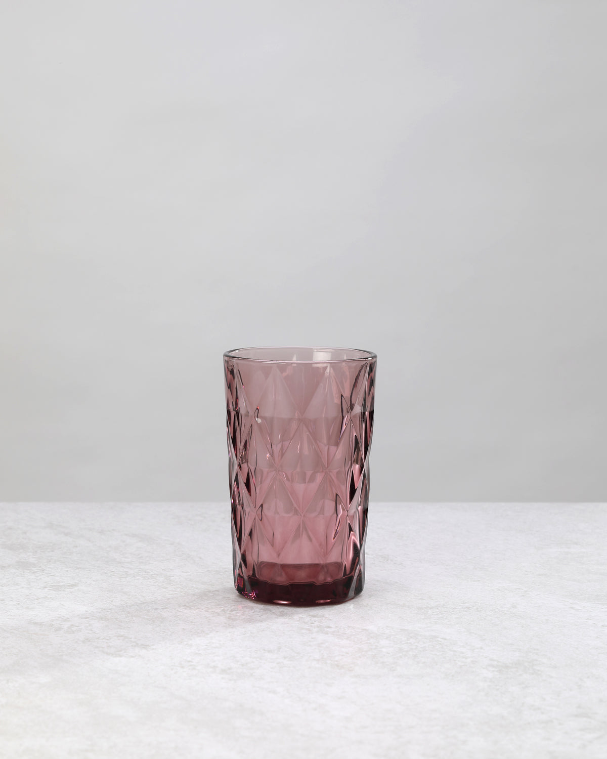 Single pink diamond cut highball glass, front view