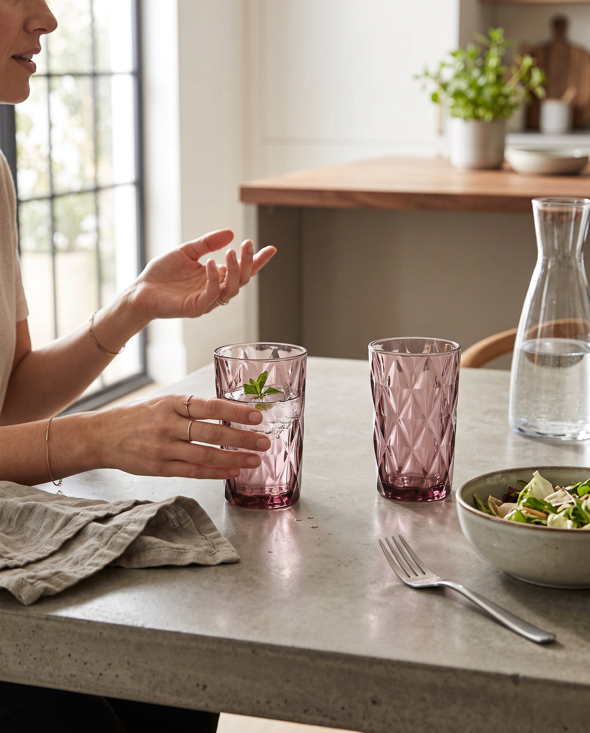 Pink diamond cut highball glasses at a lunch table with a salad bowl