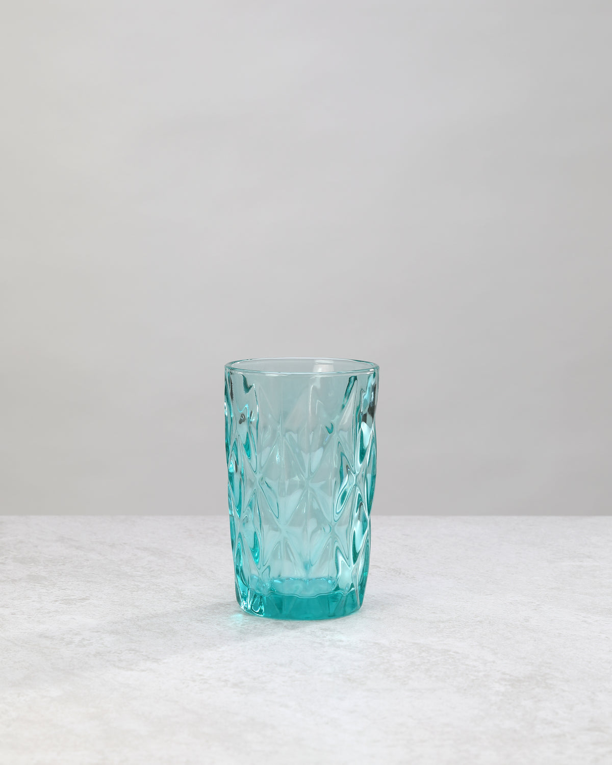 Single aqua diamond cut highball glass, front view