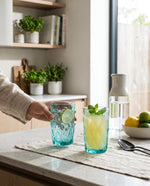 Aqua diamond cut highball glasses with lemonade and mint on a kitchen counter