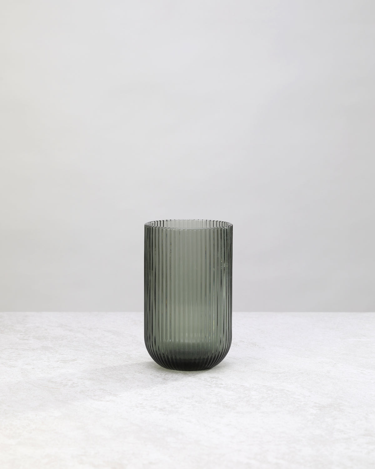 Single tall hunter green ribbed highball glass, front view