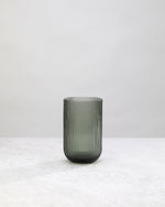 Single tall hunter green ribbed highball glass, front view