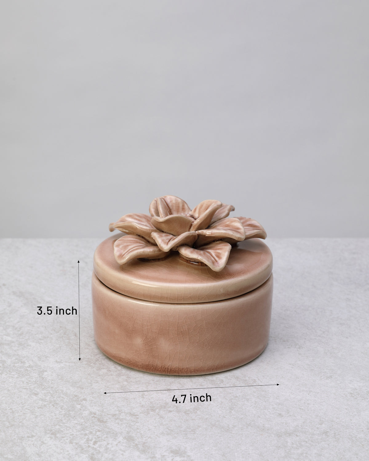 Pink glazed ceramic trinket box with its dimensions marked