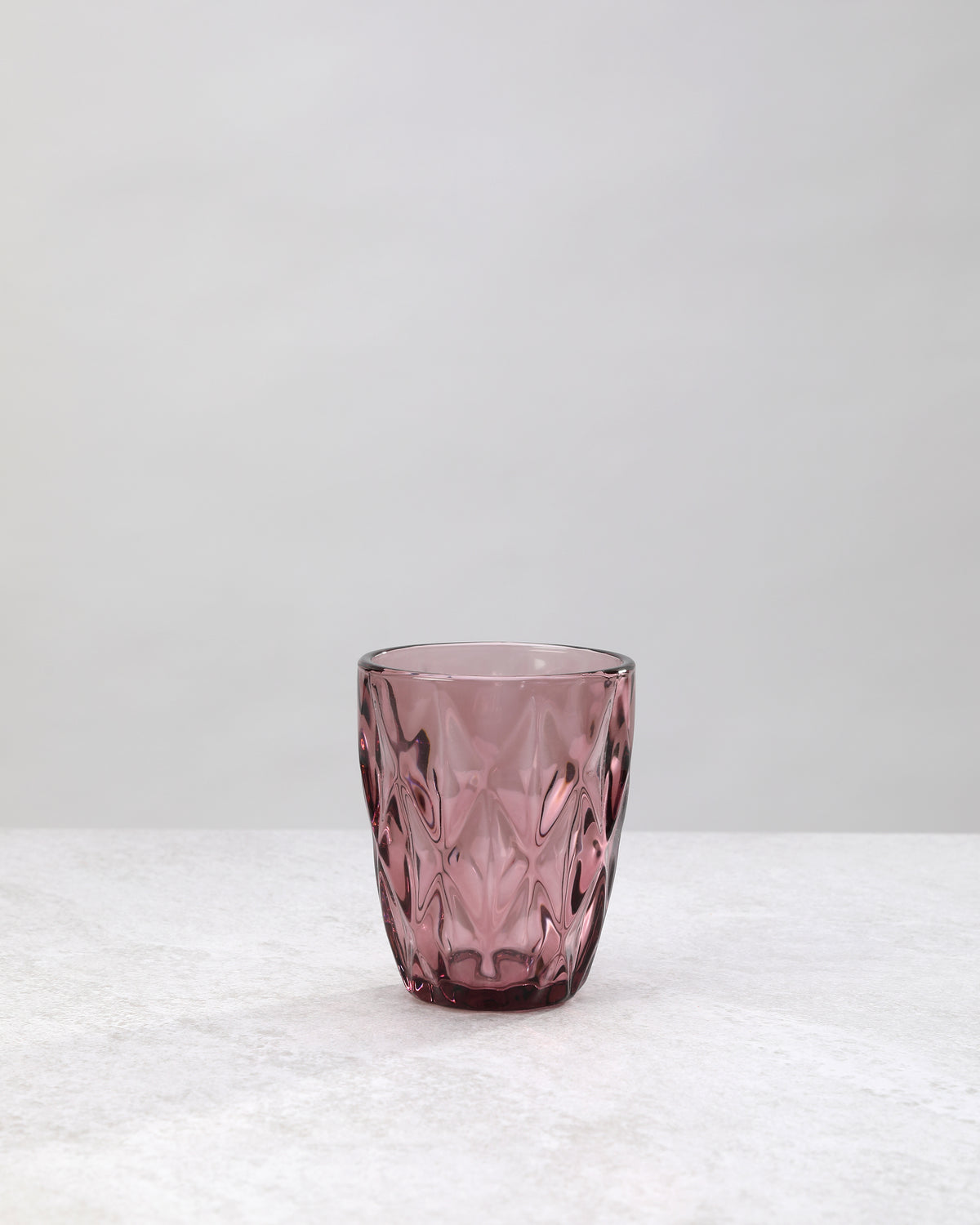 Single pink diamond cut tumbler glass, front view