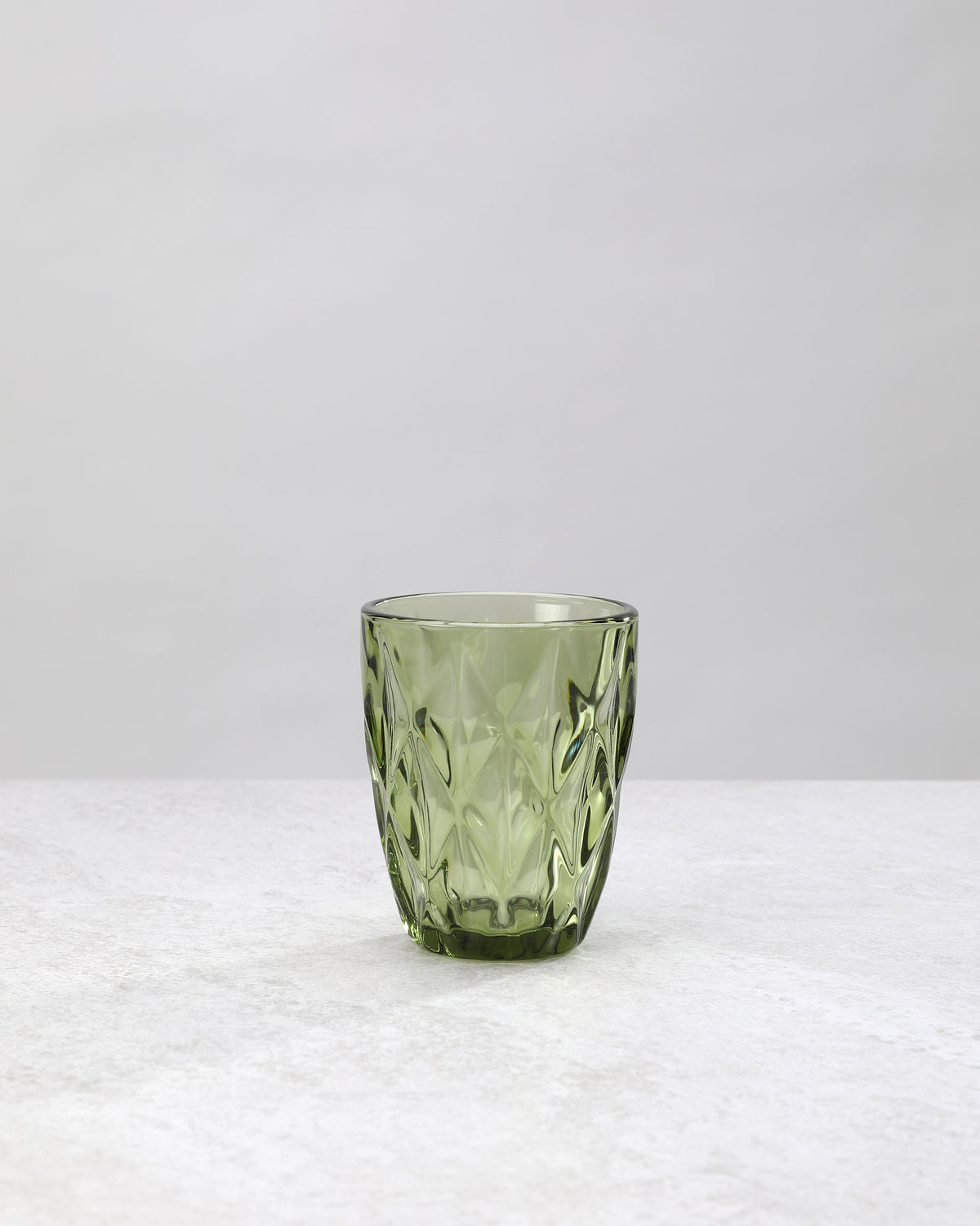 Single olive green diamond cut tumbler glass, front view