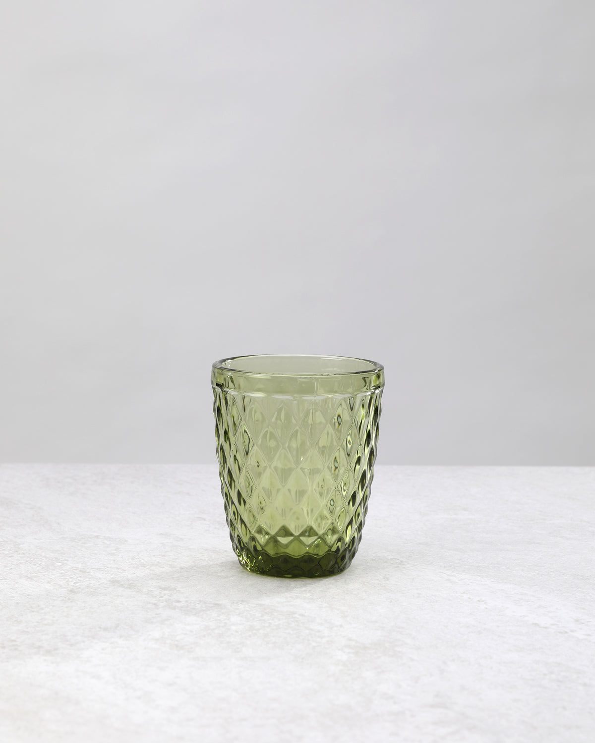 Single olive green small diamond tumbler glass, front view