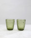 Two olive green small diamond tumbler glasses with an all-over diamond pattern, on white