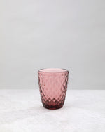 Single pink small diamond tumbler glass, front view