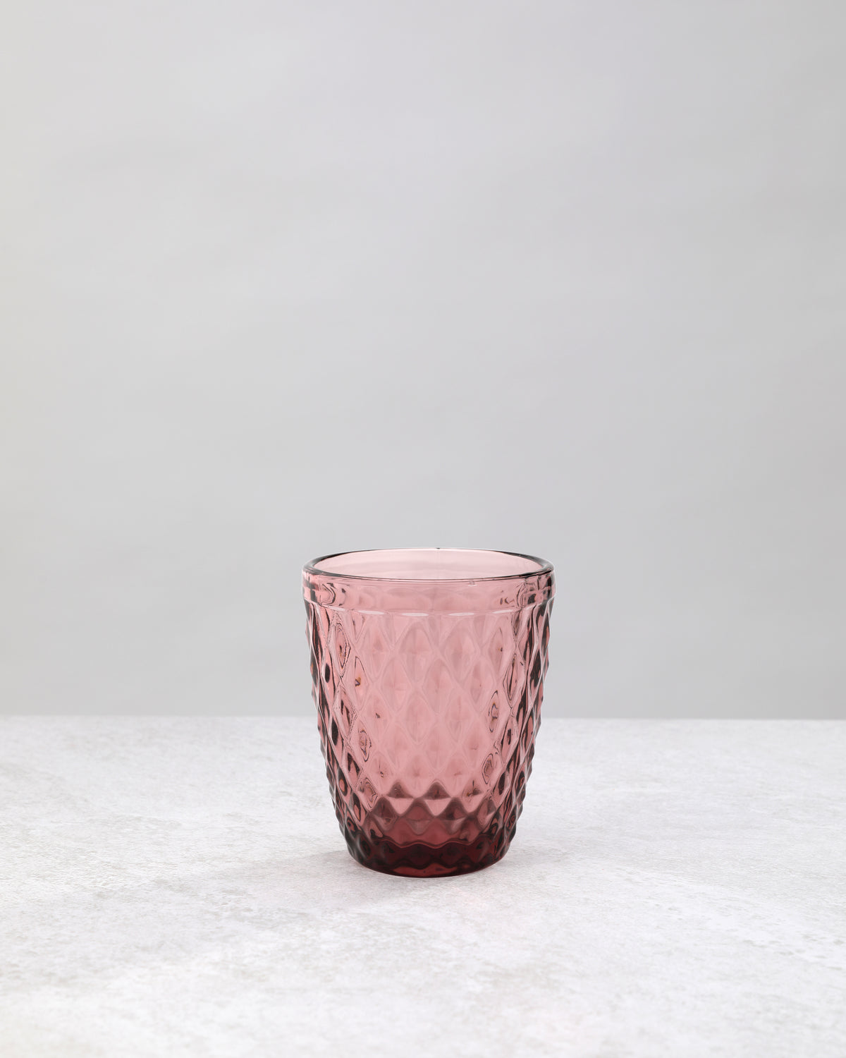 Single pink small diamond tumbler glass, front view
