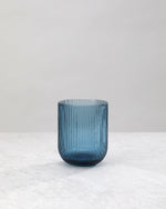 Single blue ribbed tumbler glass showing the fine vertical ribs
