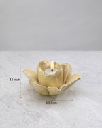 Yellow ceramic lotus tea light holder with its dimensions marked