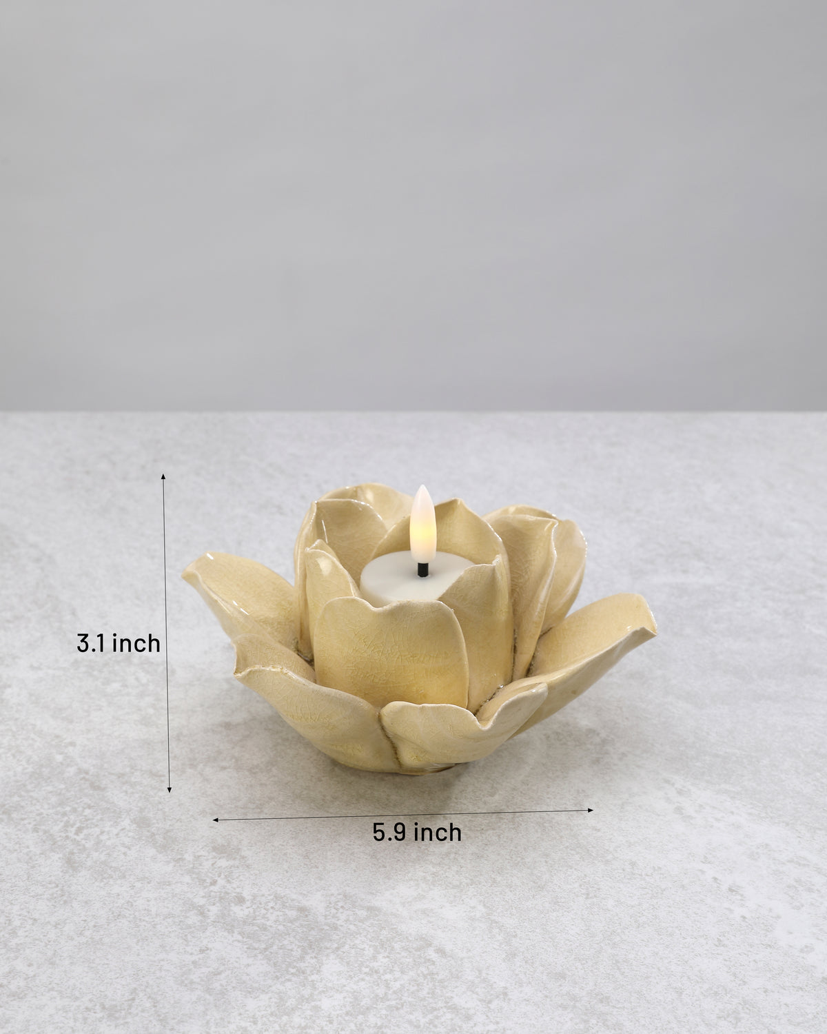 Yellow ceramic lotus tea light holder with its dimensions marked