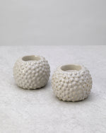 Pair of white textured ceramic tea light holders, unlit