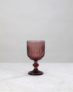 Single burgundy ribbed cut wine glass, front view