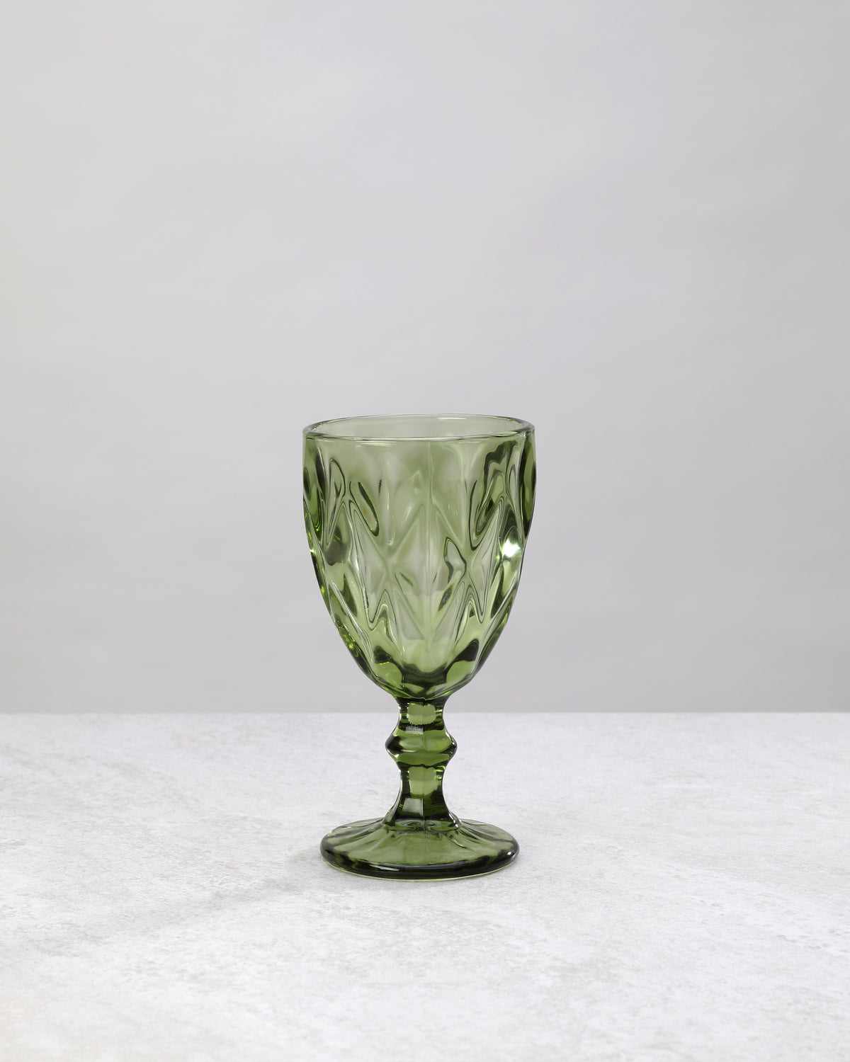 Single olive green diamond cut wine glass, front view