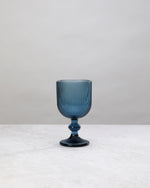 Single blue ribbed wine glass, front view
