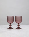 Pair of cordovan ribbed wine glasses on a white background