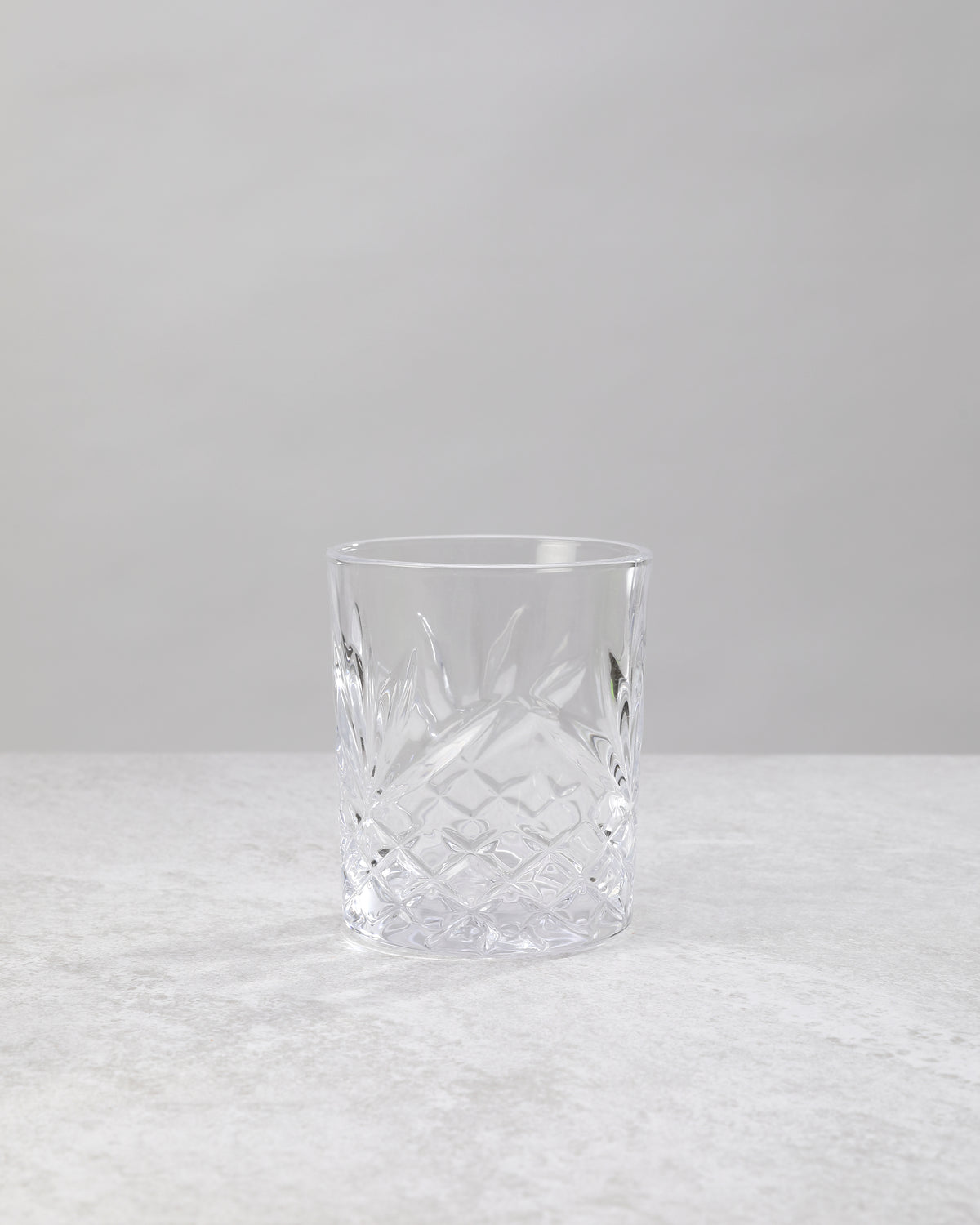 Single clear machine cut whiskey glass, front view