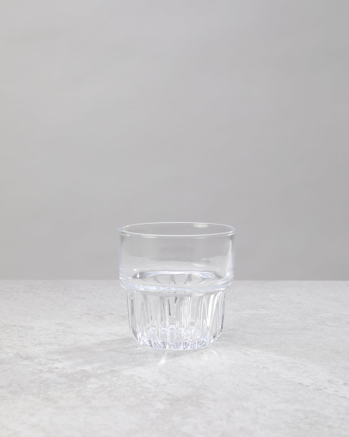 Single clear water glass showing the faceted base