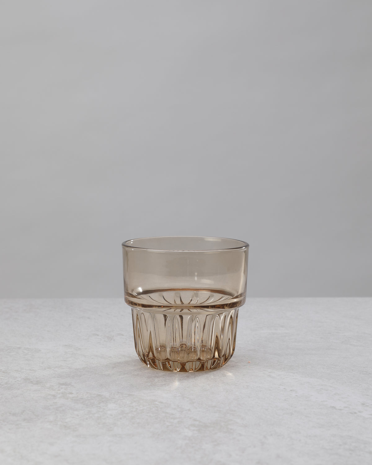 Single amber water glass showing the faceted base