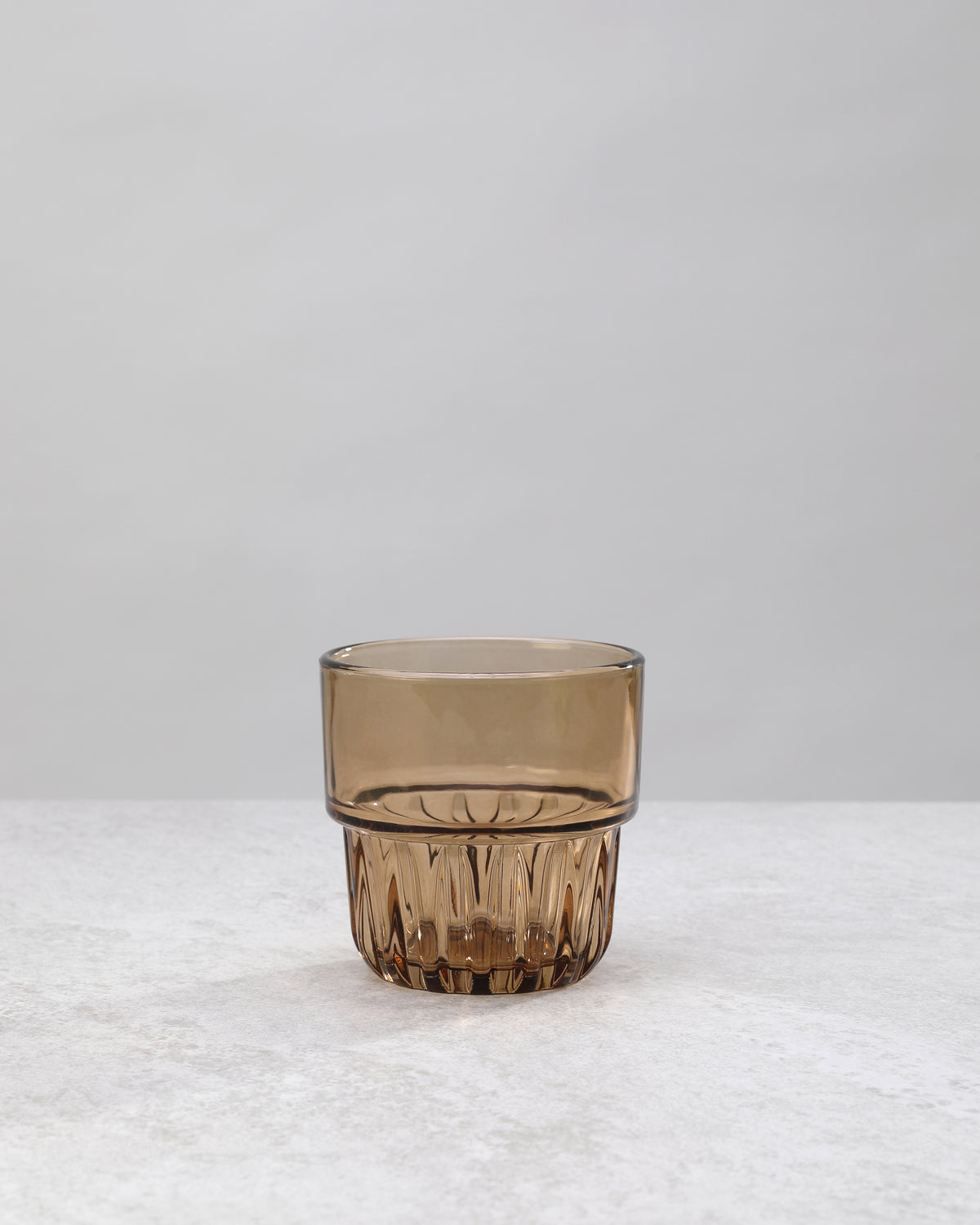 Single brown water glass showing the faceted base